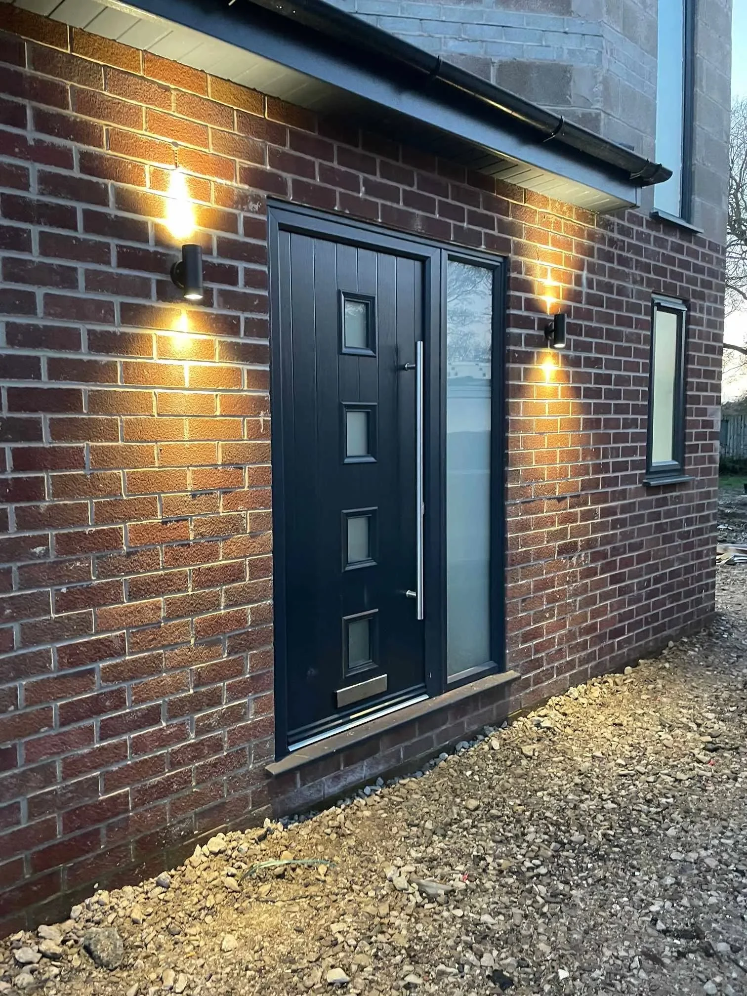 Exterior door with modern wall lighting